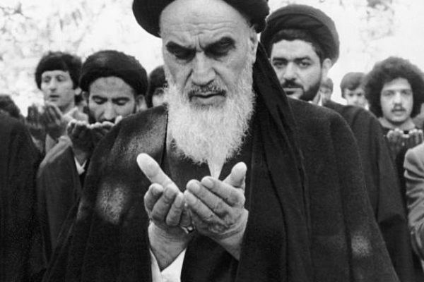 Ayatollah Ruhollah Khomeini prays in the garden of his villa in Pontchartrain, near Paris, where he is staying during his exile from Iran.